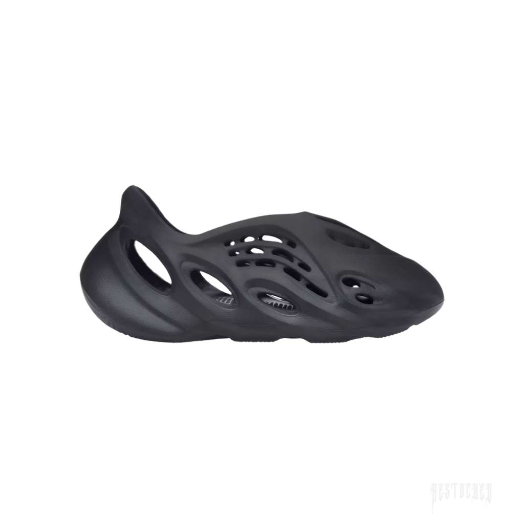 ADIDAS YEEZY FOAM RNR ONYX, a sleek black slip-on sneaker made from EVA foam with oval cutouts.