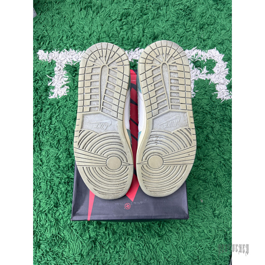 Pre-owned Jordan 1 Retro High Turbo Green sneakers, size 10, showing worn outsoles on a green rug.