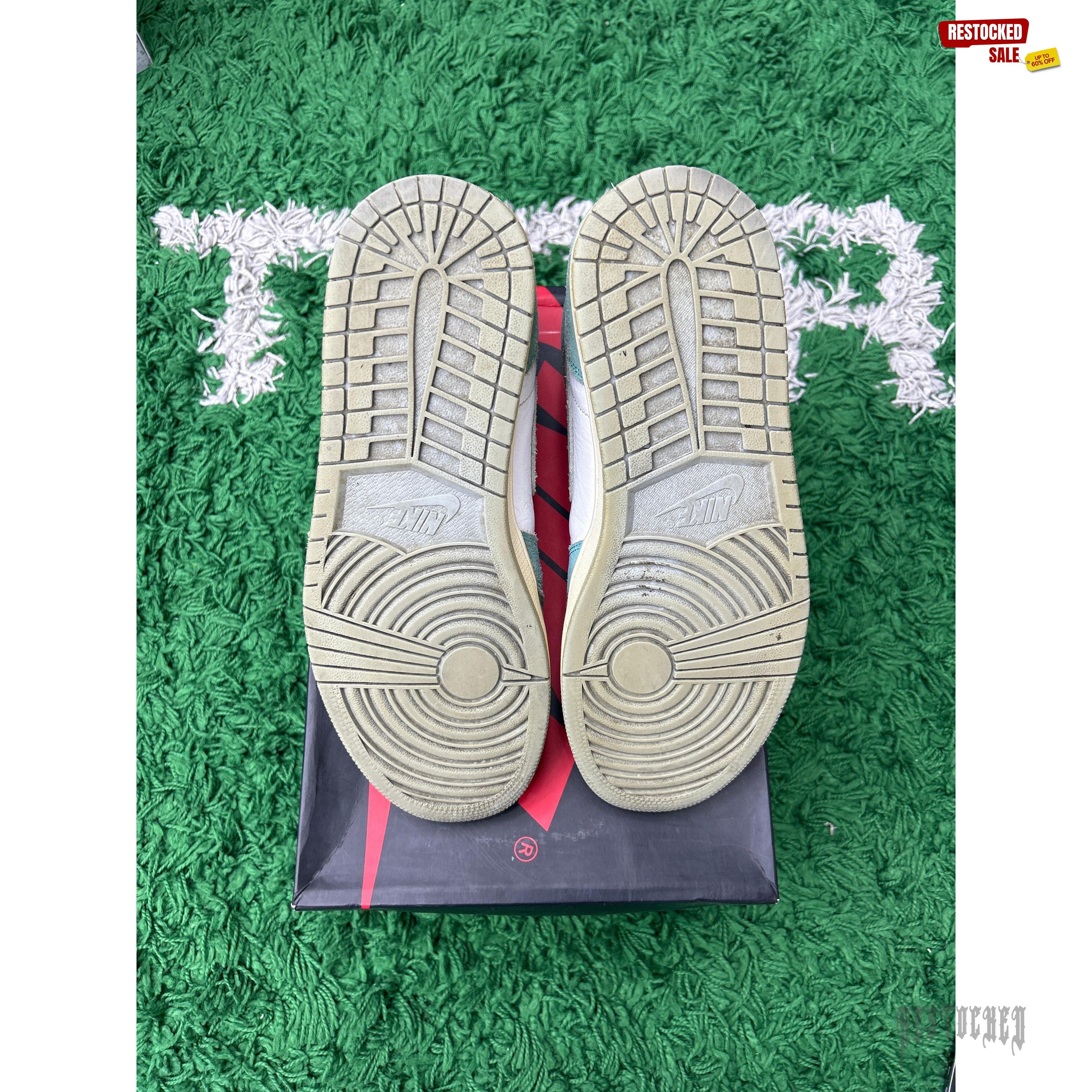 Pre-owned Jordan 1 Retro High Turbo Green sneakers, size 10, showing worn outsoles on a green rug.