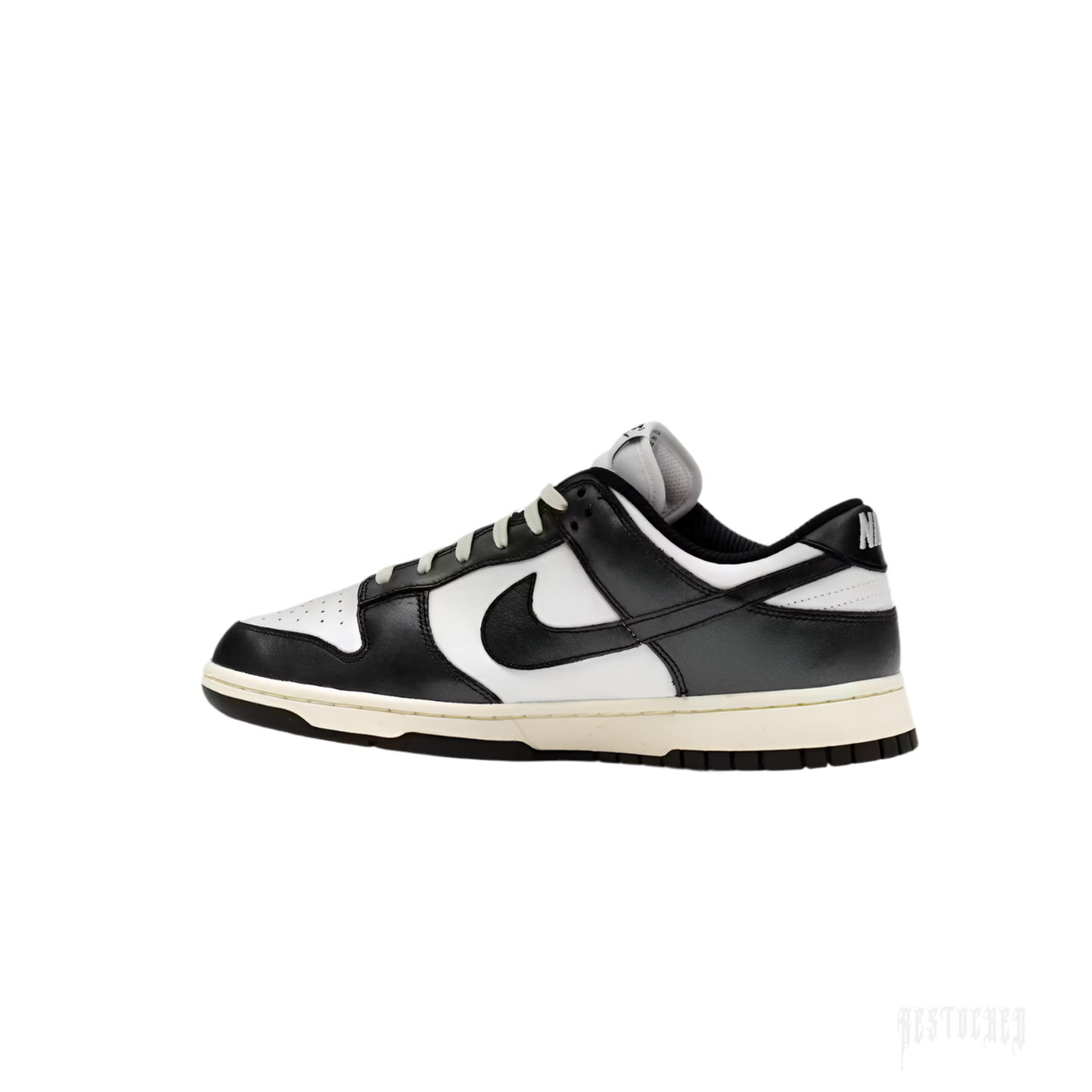 NIKE DUNK LOW VINTAGE PANDA women's sneaker, black and white leather with cream midsole.