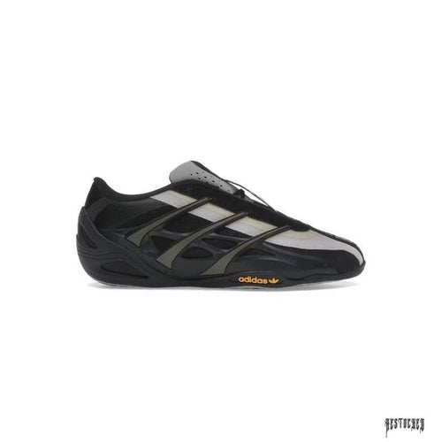 Adidas Adiracer GT Bad Bunny x Mercedes AMG Branch Sand sneaker, black with gray stripes and gold Adidas logo.