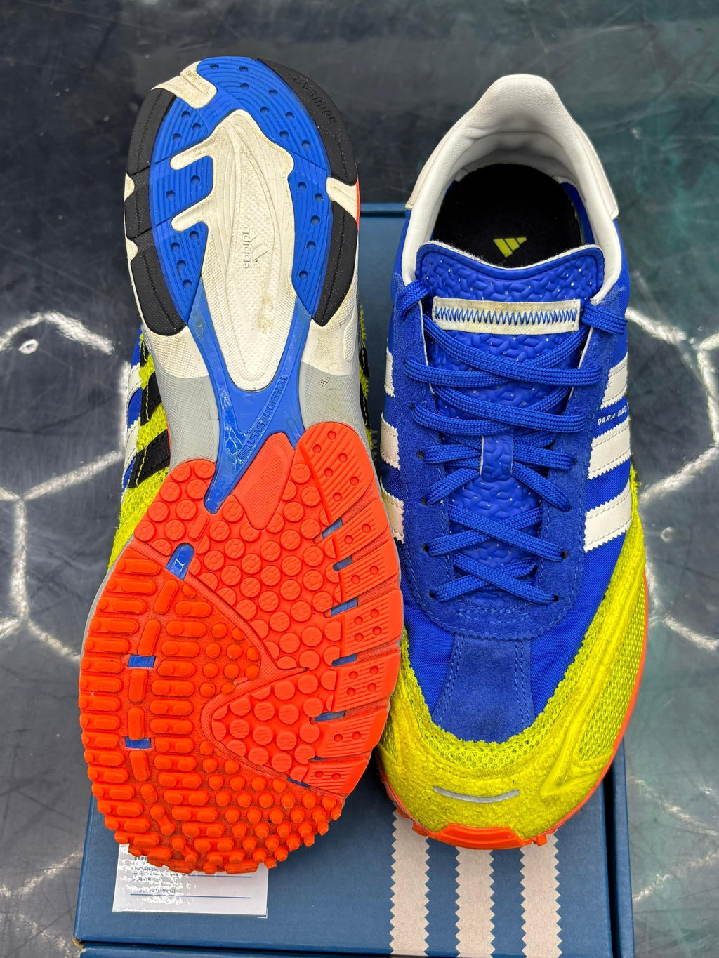 ADIDAS ADIZERO SL 72 Bad Bunny Blue Pre-Owned Size 9, with vibrant blue suede, neon yellow mesh, white stripes, and bright orange outsole.