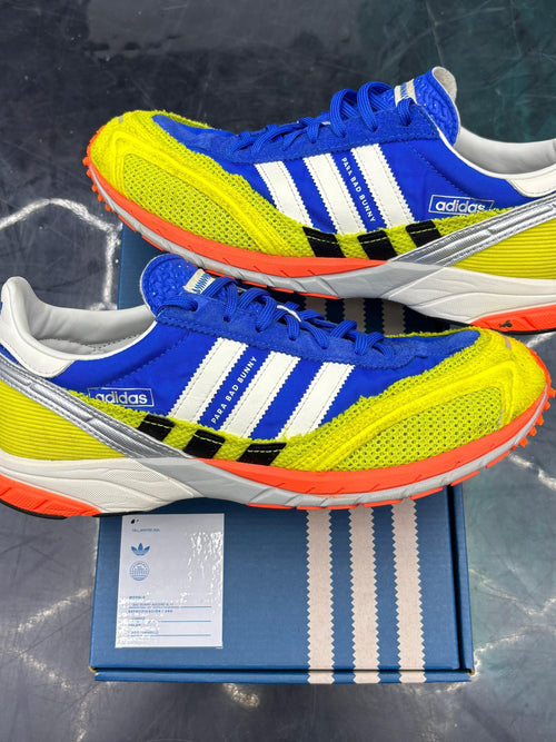 Pre-owned Adidas Adizero SL 72 Bad Bunny Blue sneakers, size 9, with yellow mesh, white stripes, and orange soles.