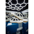 ADIDAS BADBO 1.0 RISE sneakers, white and black with blue accents, stacked on blue Adidas boxes.