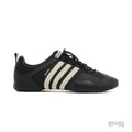 Adidas Bad Bunny Ballerina Black Chalk sneaker with white stripes and "benito" text.