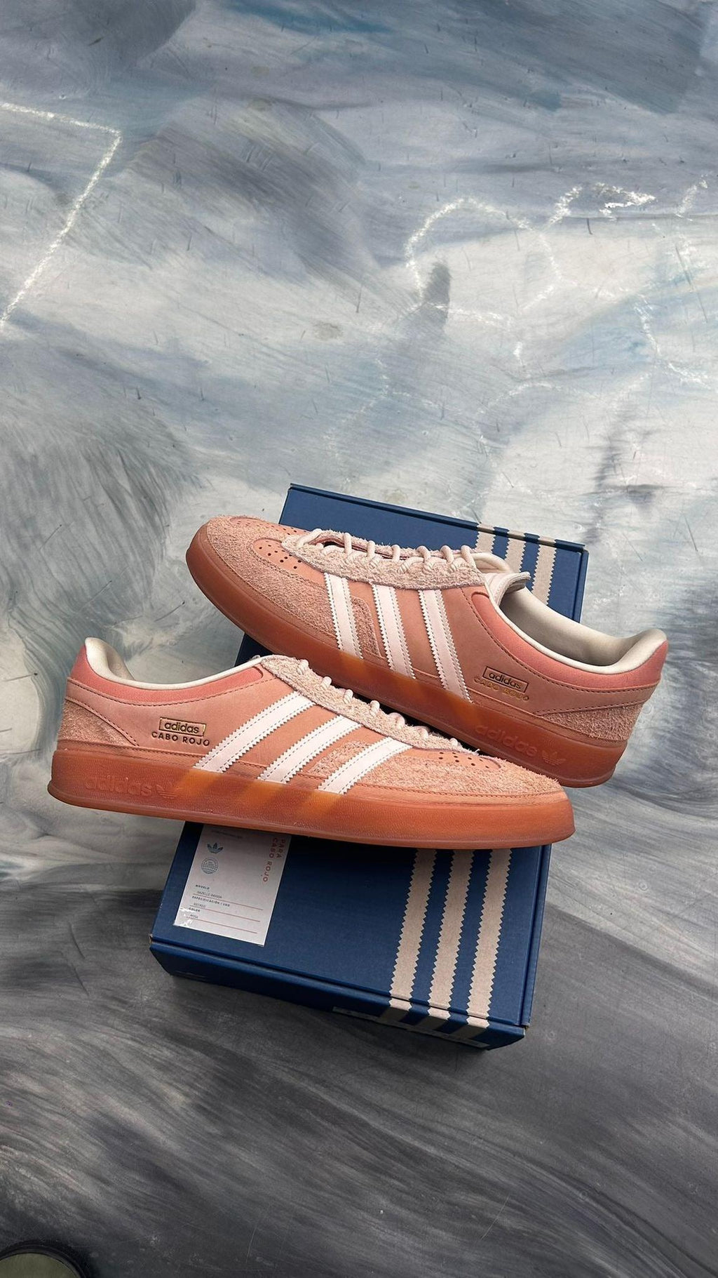 ADIDAS GAZELLE INDOOR BAD BUNNY CABO ROJO SIZE 12, pre-owned, with pink suede upper, white stripes, and gum sole, on blue box.