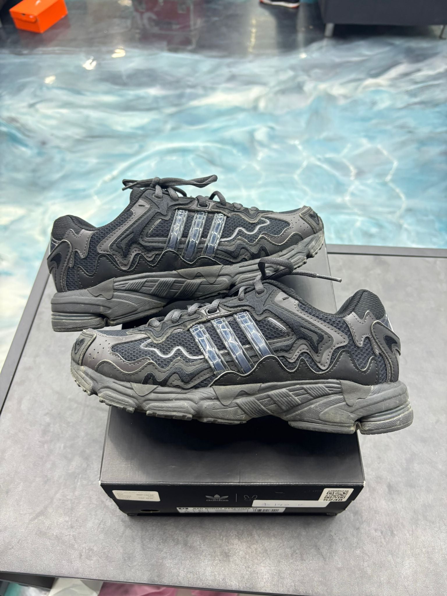 Pre-owned Adidas Response CL Bad Bunny Triple Black sneakers, size 7, with wavy overlays and shiny stripes.