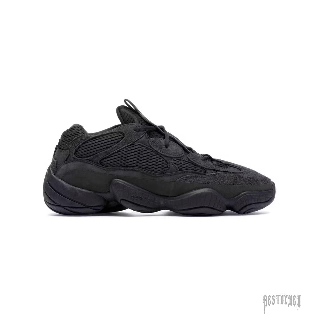 Adidas Yeezy 500 Utility Black sneaker, featuring a sleek all-black mesh and suede design with a chunky sole.