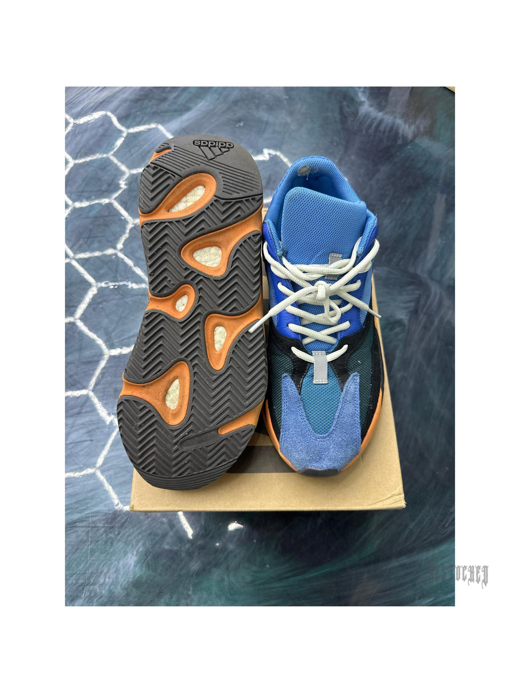 Adidas Yeezy Boost 700 Bright Blue 11.5 pre-owned sneaker, showing top-down view of blue/black upper and orange Boost sole.
