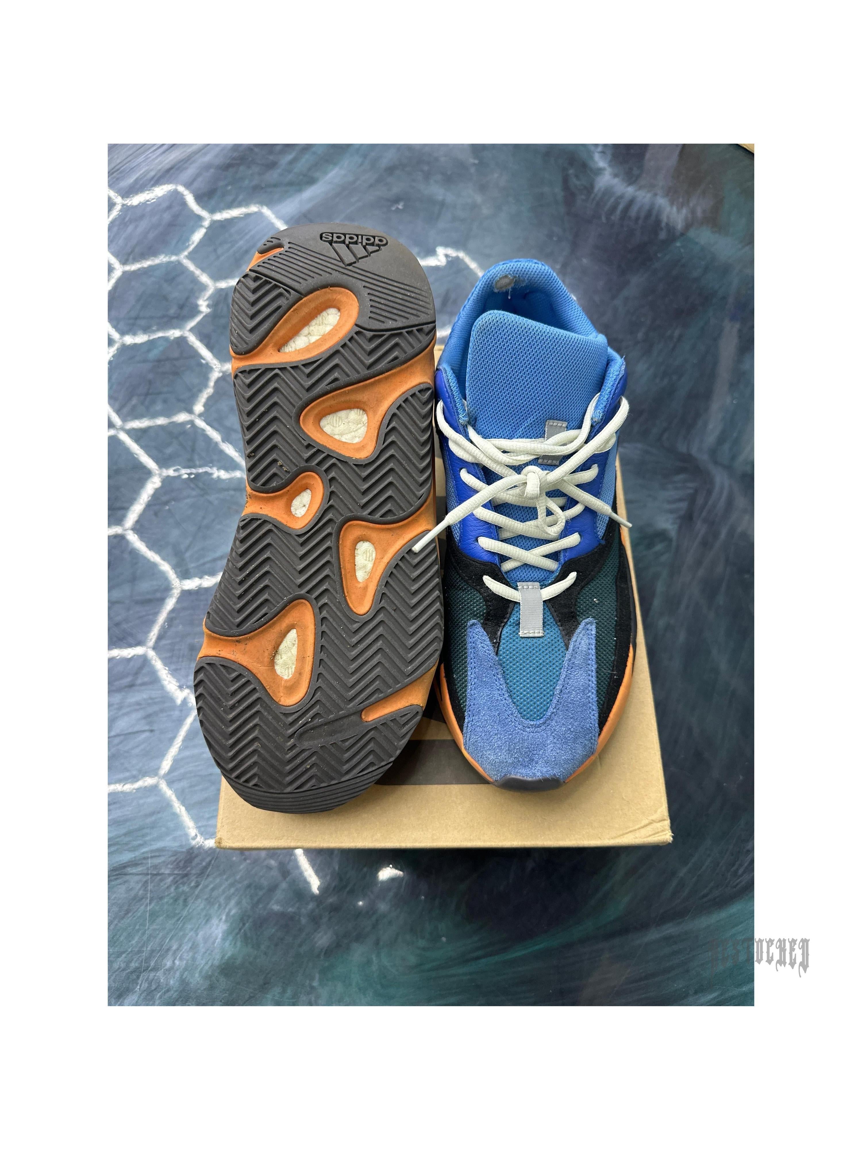 Adidas Yeezy Boost 700 Bright Blue 11.5 pre-owned sneaker, showing top-down view of blue/black upper and orange Boost sole.
