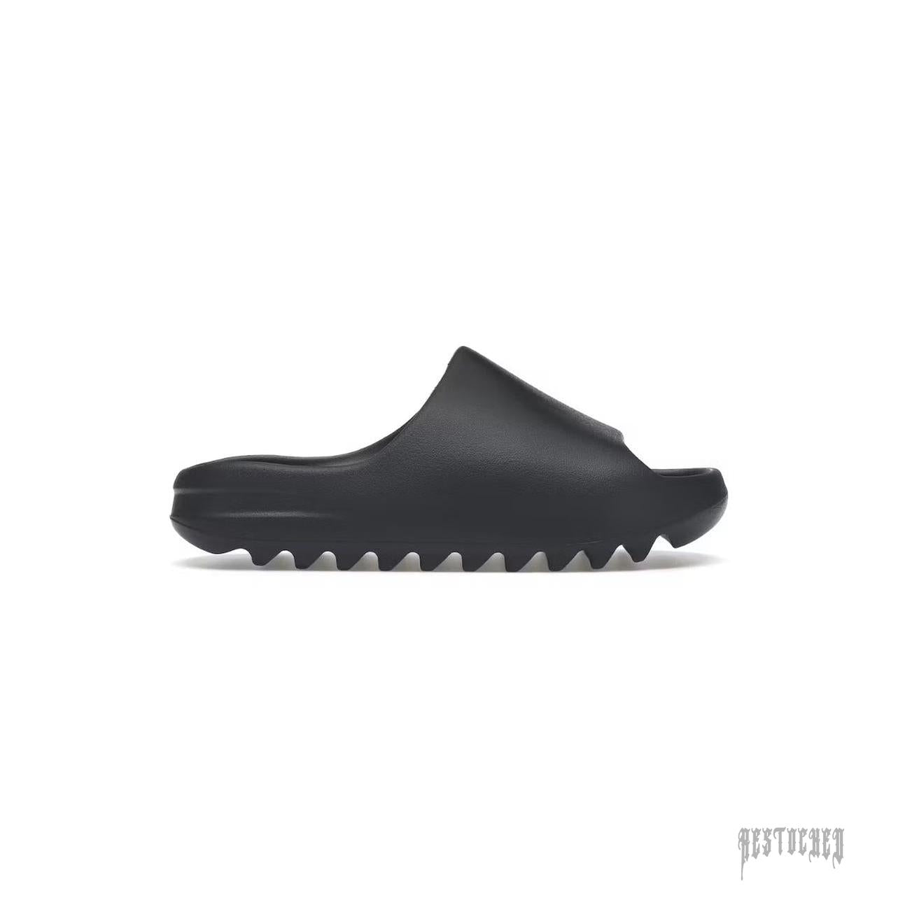 ADIDAS YEEZY SLIDE in Slate Grey, made from lightweight EVA foam with a minimalist design and serrated sole.