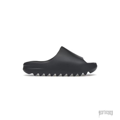 ADIDAS YEEZY SLIDE in Slate Grey, made from lightweight EVA foam with a minimalist design and serrated sole.