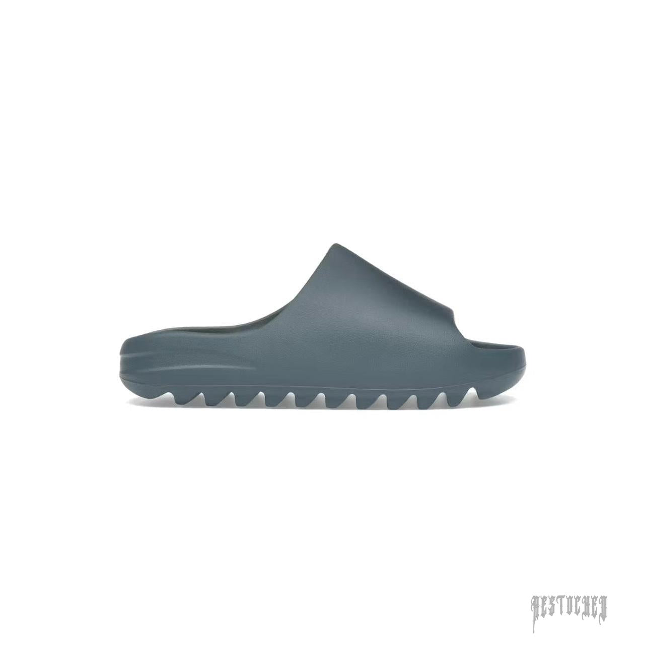 ADIDAS YEEZY SLIDE SLATE MARINE, a minimalist dark teal foam slide with a thick, ridged sole.