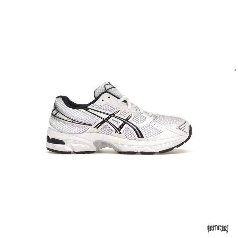 ASICS GEL 1130 GS white and black athletic shoe with mesh upper and black sole.