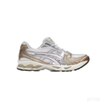 ASICS GEL-KAYANO 14 "Olympic Medals" sneaker with white mesh, cream leather, and metallic gold/silver accents.
