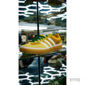 Bad Bunny Adidas Gazelle Indoor Vega Baja in yellow suede with white stripes and green laces.
