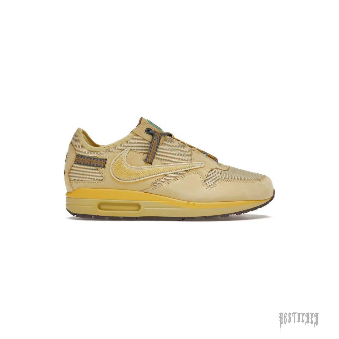 Nike Air Max 1 Travis Scott Cactus Jack "Saturn Gold" sneaker, tan and gold with unique lacing.