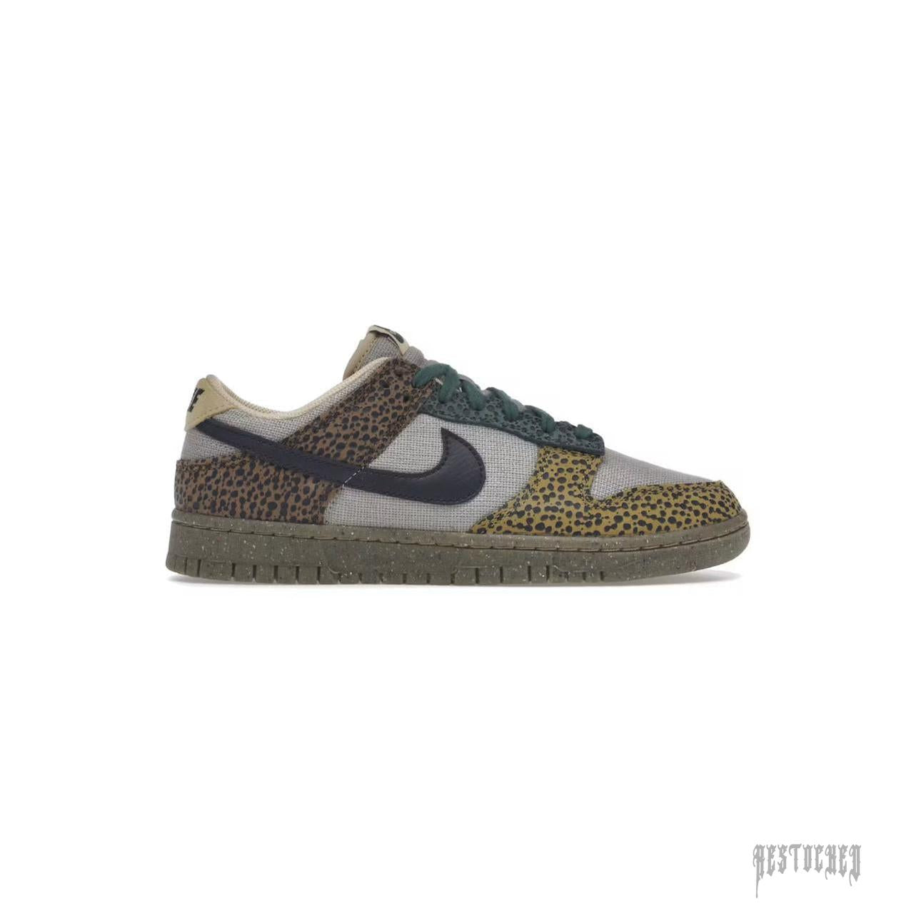 NIKE DUNK LOW SAFARI GOLDEN MOSS sneaker with leopard print overlays, green laces, and speckled sole.