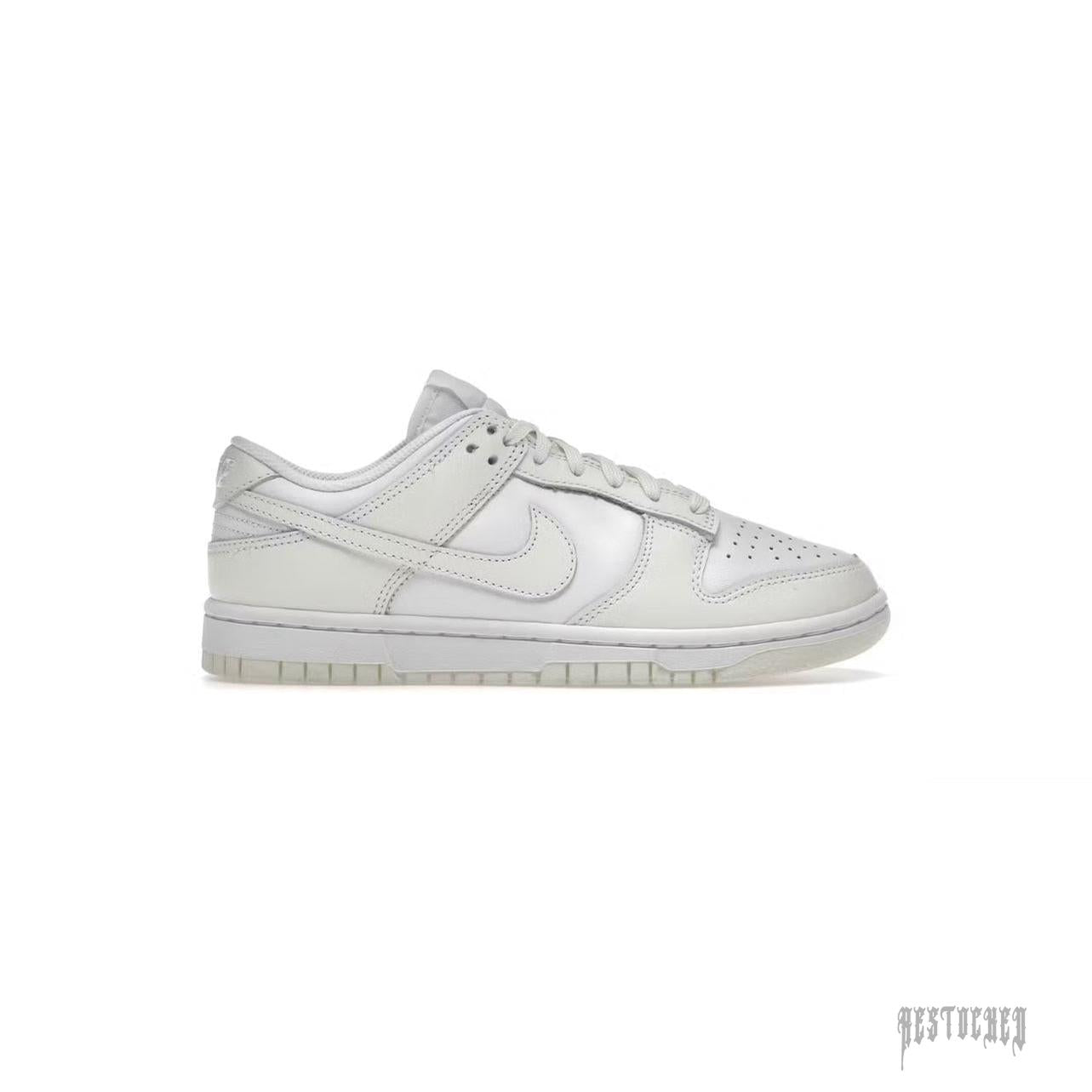 Nike Dunk Low Retro "Coconut Milk" women's sneaker, off-white leather with matching laces and sole.