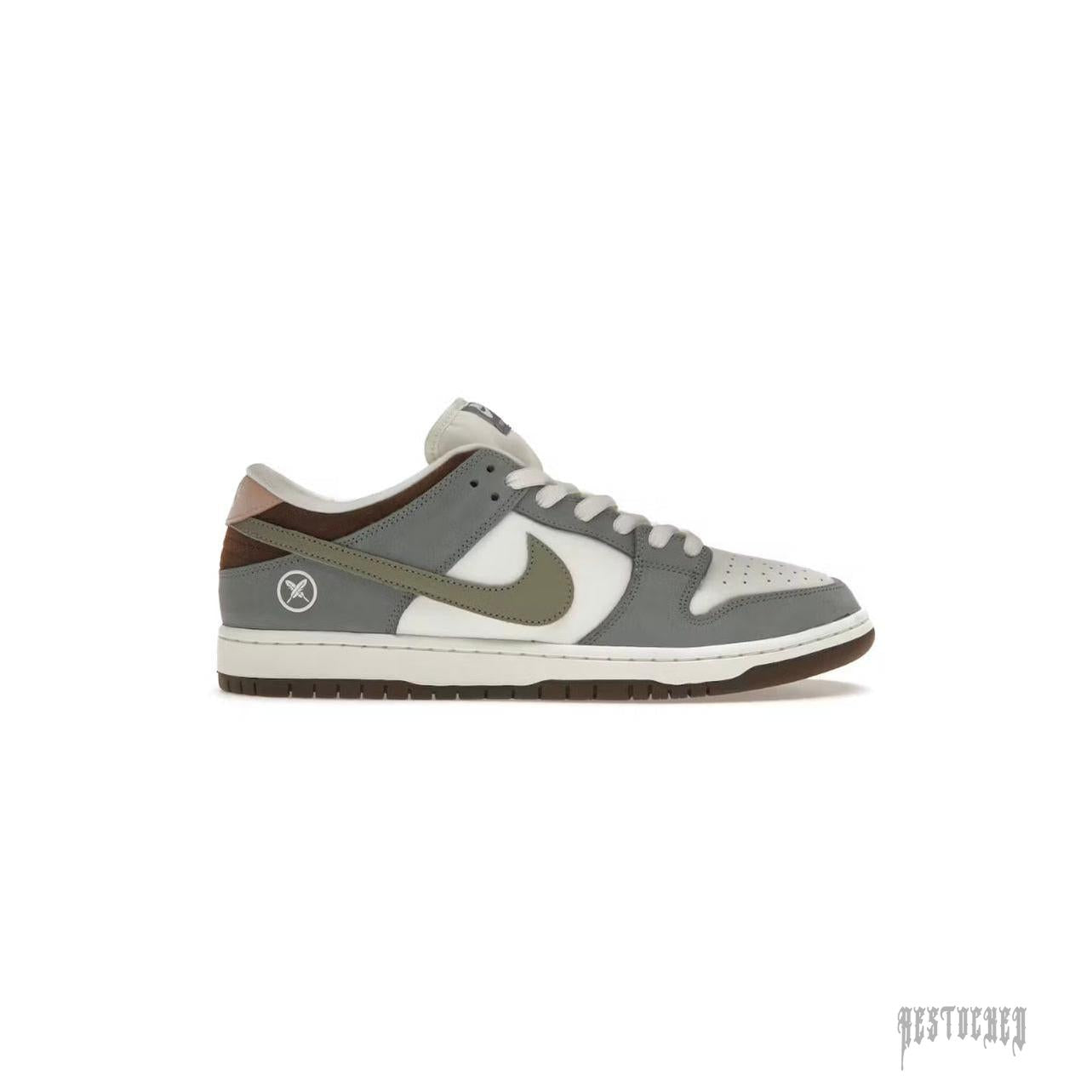 NIKE SB DUNK LOW YUTO HORIGOME sneaker with grey, white, brown, and olive accents, featuring a custom heel logo.