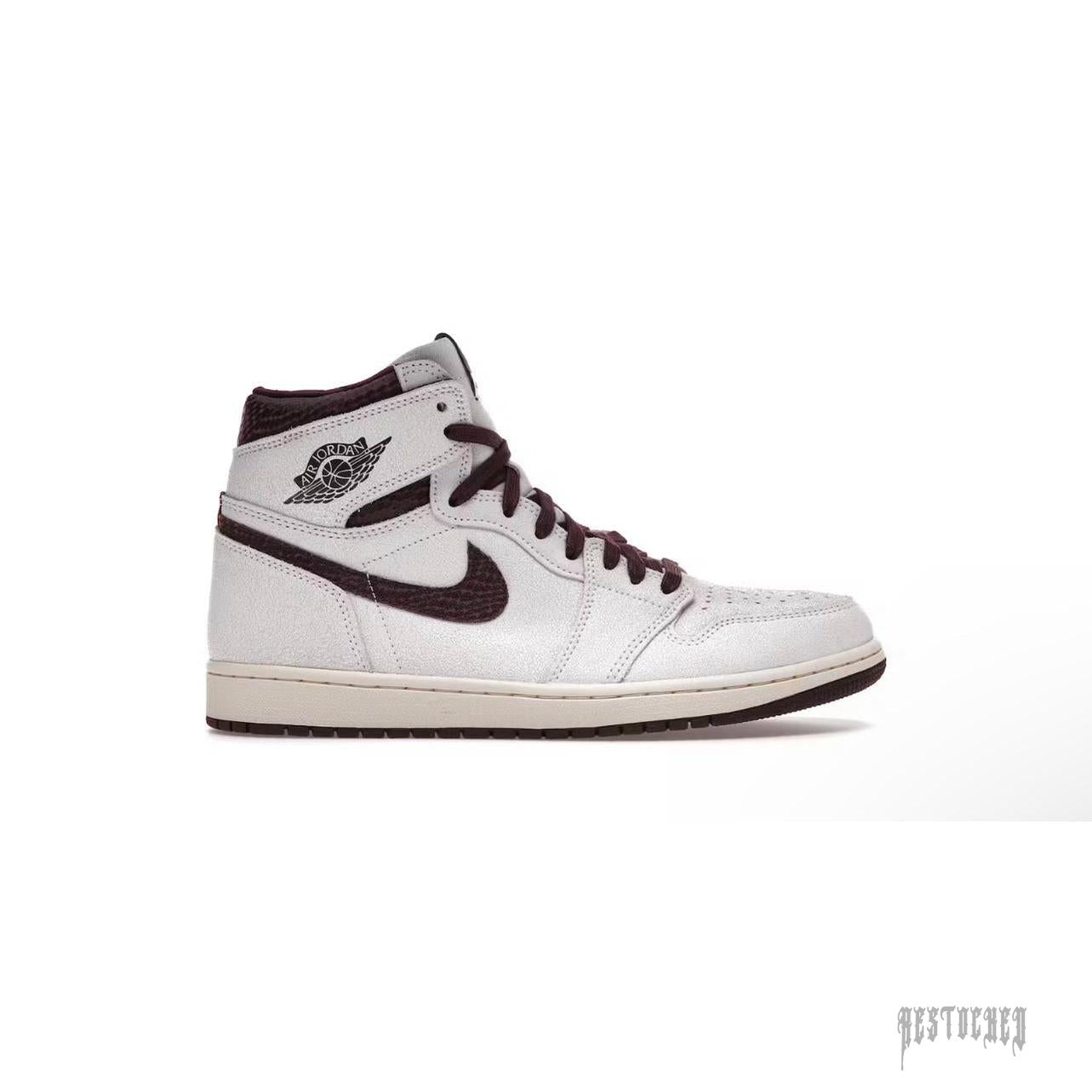 JORDAN 1 RETRO HIGH OG A MA MANIÉRE sneaker, white cracked leather upper, burgundy accents, and black swoosh.