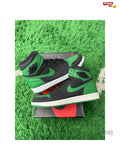 Pre-owned Jordan 1 Retro High Pine Green Black sneakers, size 10.5, on a box and green turf.
