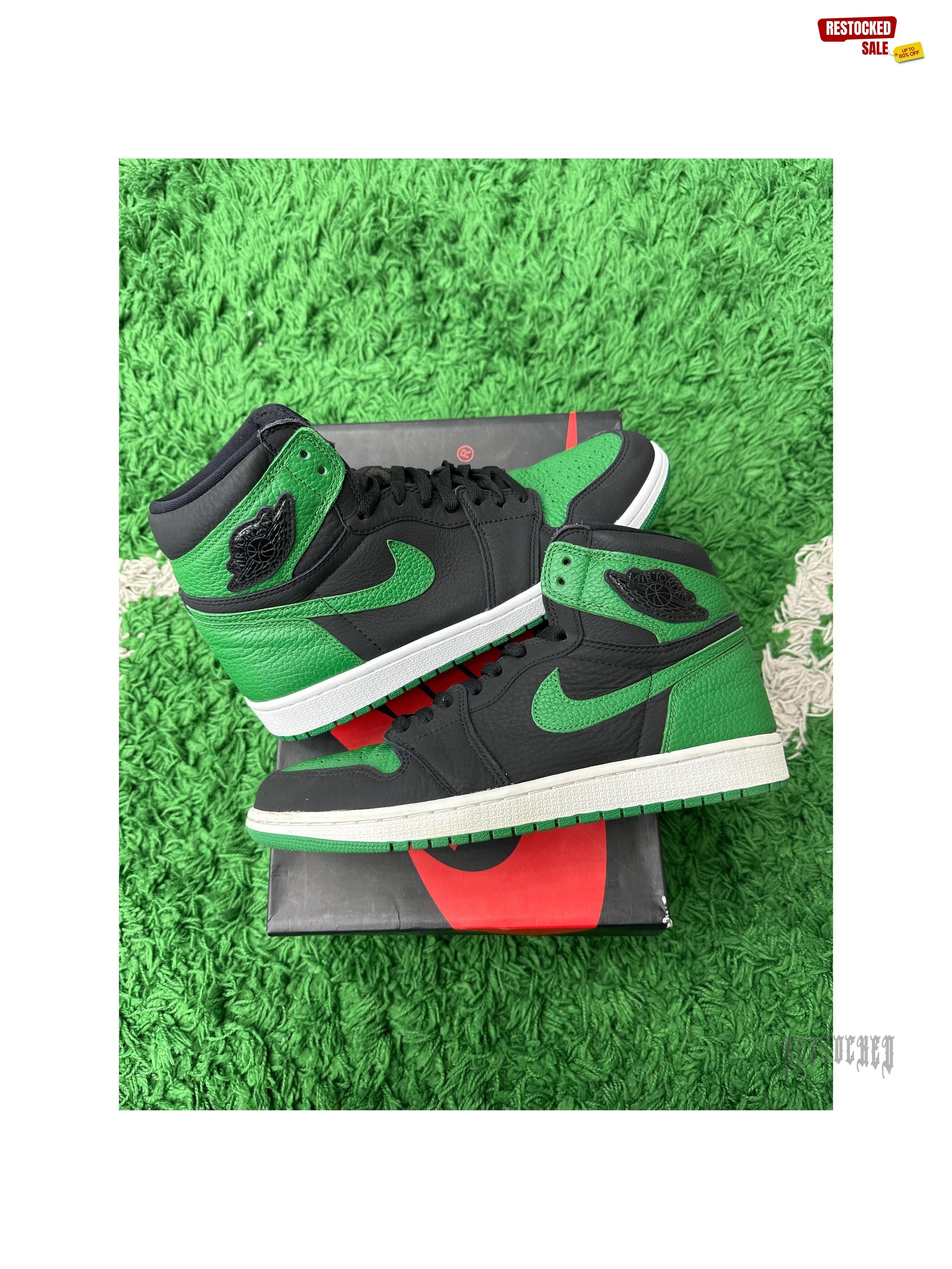 Pre-owned Jordan 1 Retro High Pine Green Black sneakers, size 10.5, on a box and green turf.