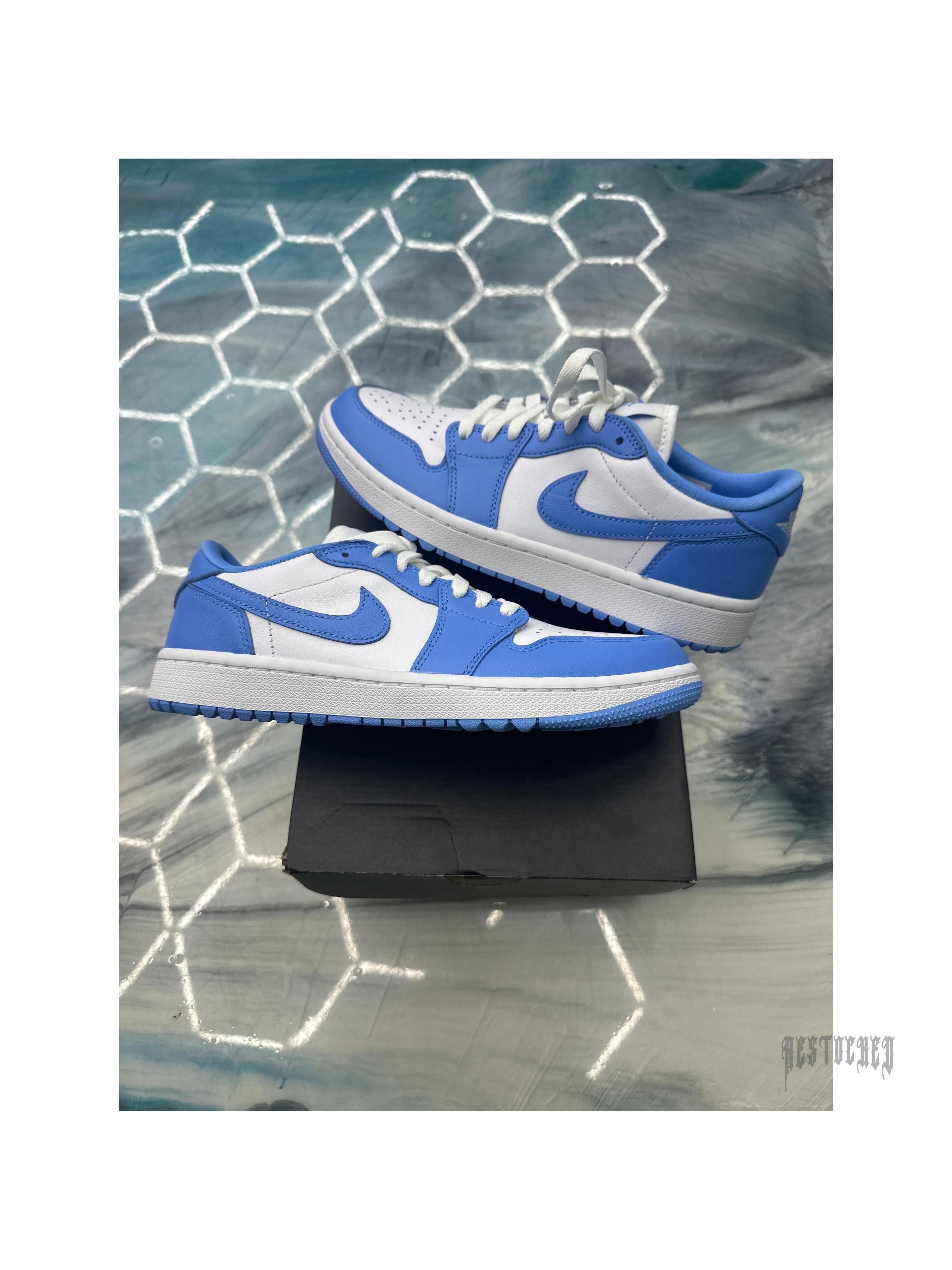 Jordan 1 Retro Low Golf UNC, white and blue leather sneakers, size 7, on a black box.