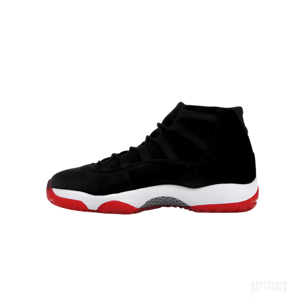 JORDAN 11 RETRO BRED VELVET women's sneaker with black velvet upper, white midsole, and red outsole.