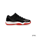 JORDAN 11 RETRO LOW BRED (GS) sneaker with black patent leather, mesh upper, white midsole, and red outsole.