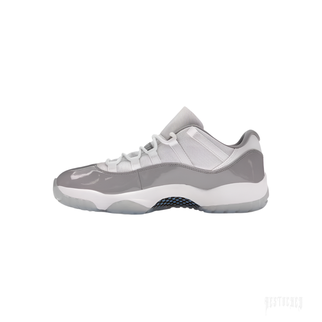 Jordan 11 Retro Low Cement Grey sneaker, side view. Features grey patent leather, white mesh, and icy blue outsole.