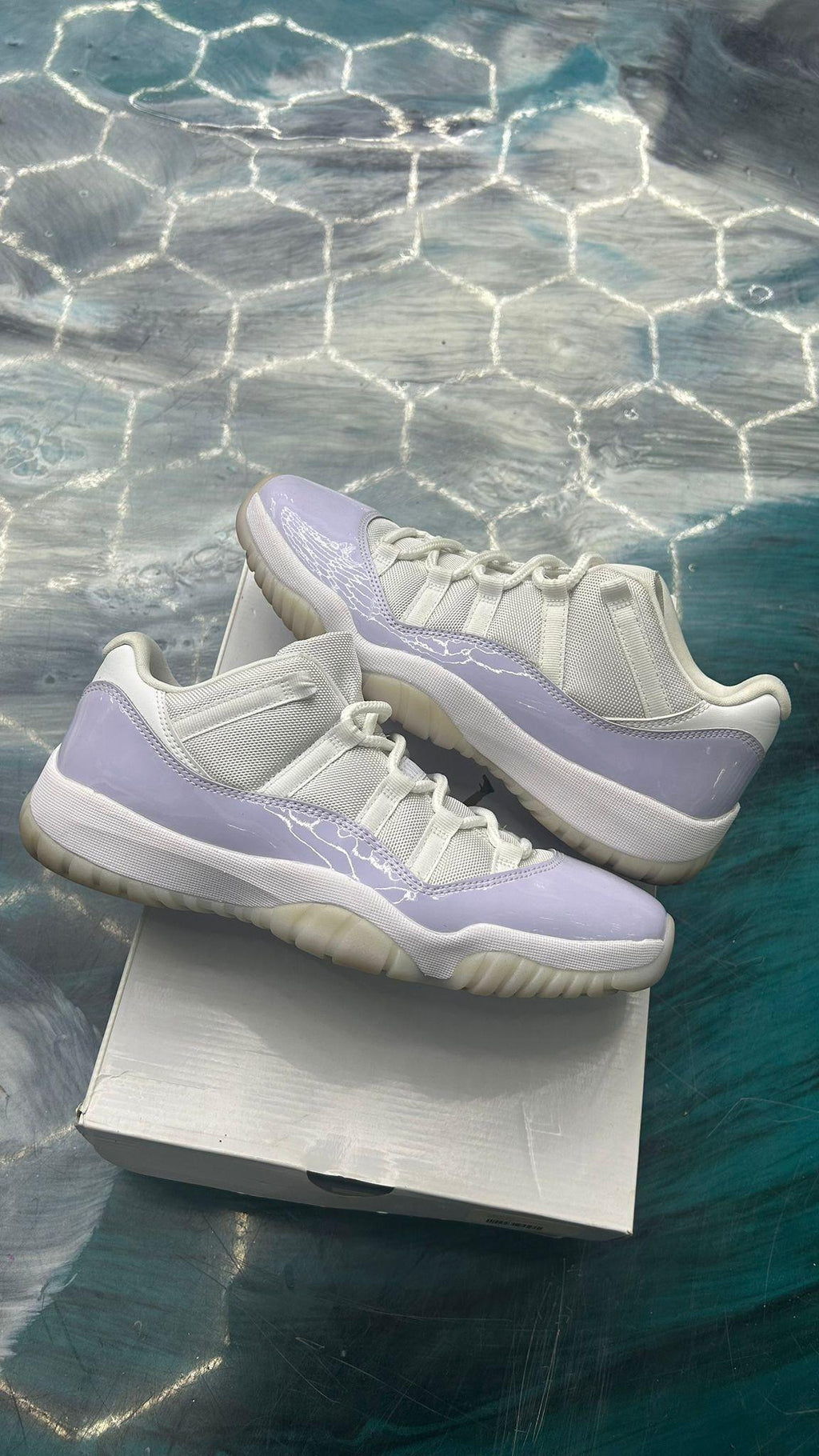 JORDAN 11 RETRO LOW PURE VIOLET (WOMENS) sneakers, white mesh upper with glossy light purple patent leather.