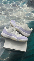 JORDAN 11 RETRO LOW PURE VIOLET (WOMENS) sneakers, white mesh upper with glossy light purple patent leather.