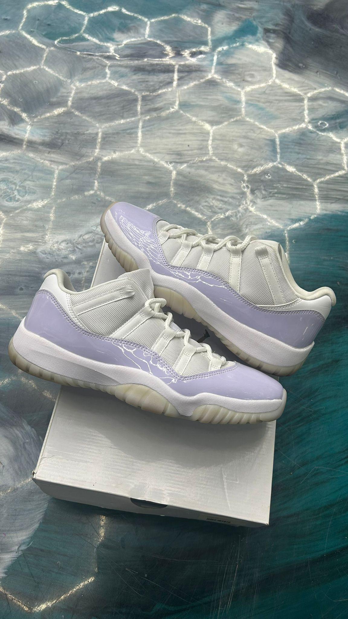 JORDAN 11 RETRO LOW PURE VIOLET (WOMENS) sneakers, white mesh upper with glossy light purple patent leather.