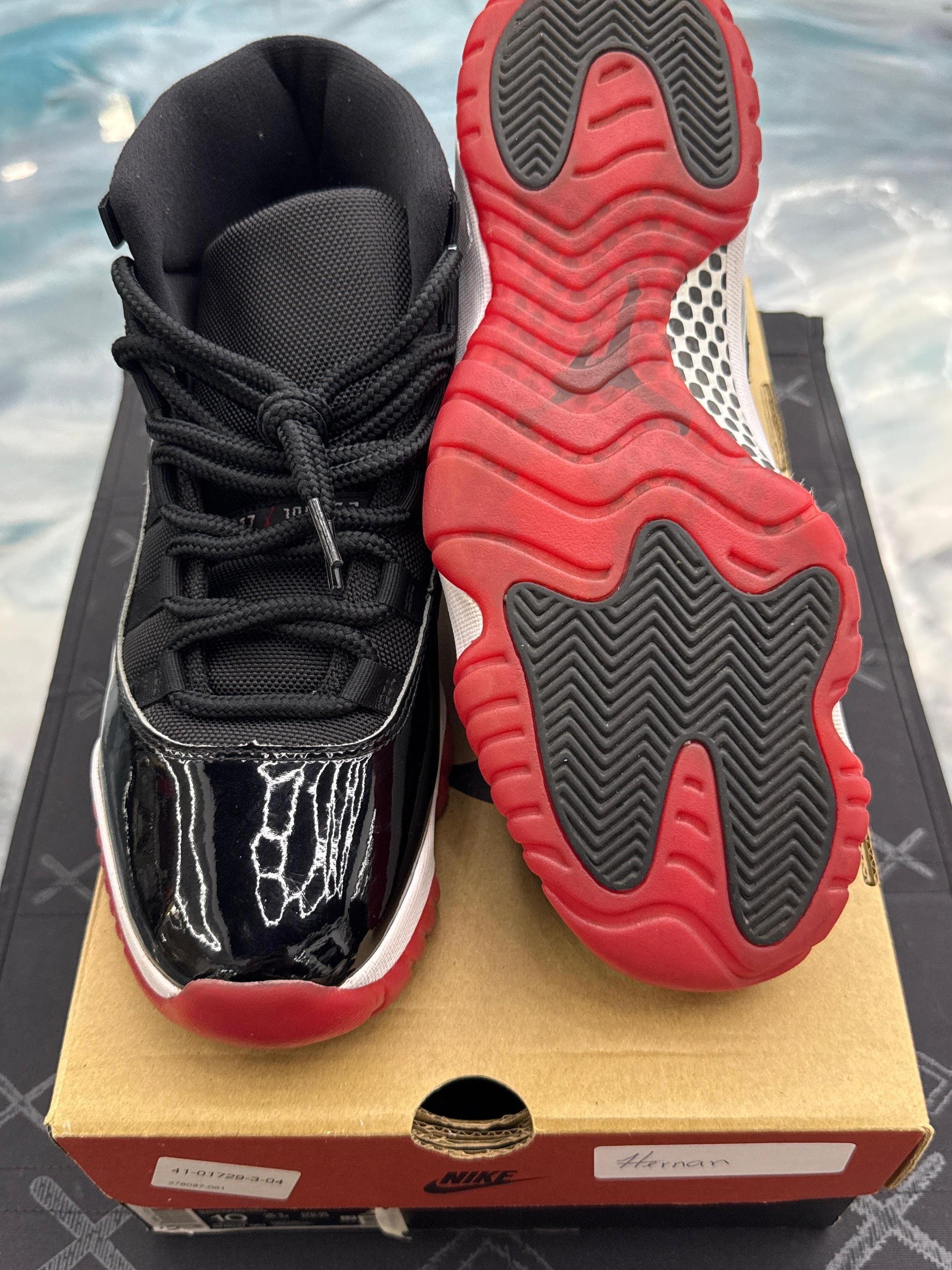 Pre-owned Jordan 11 Retro Playoff Bred size 10 sneakers with black patent leather and red soles.