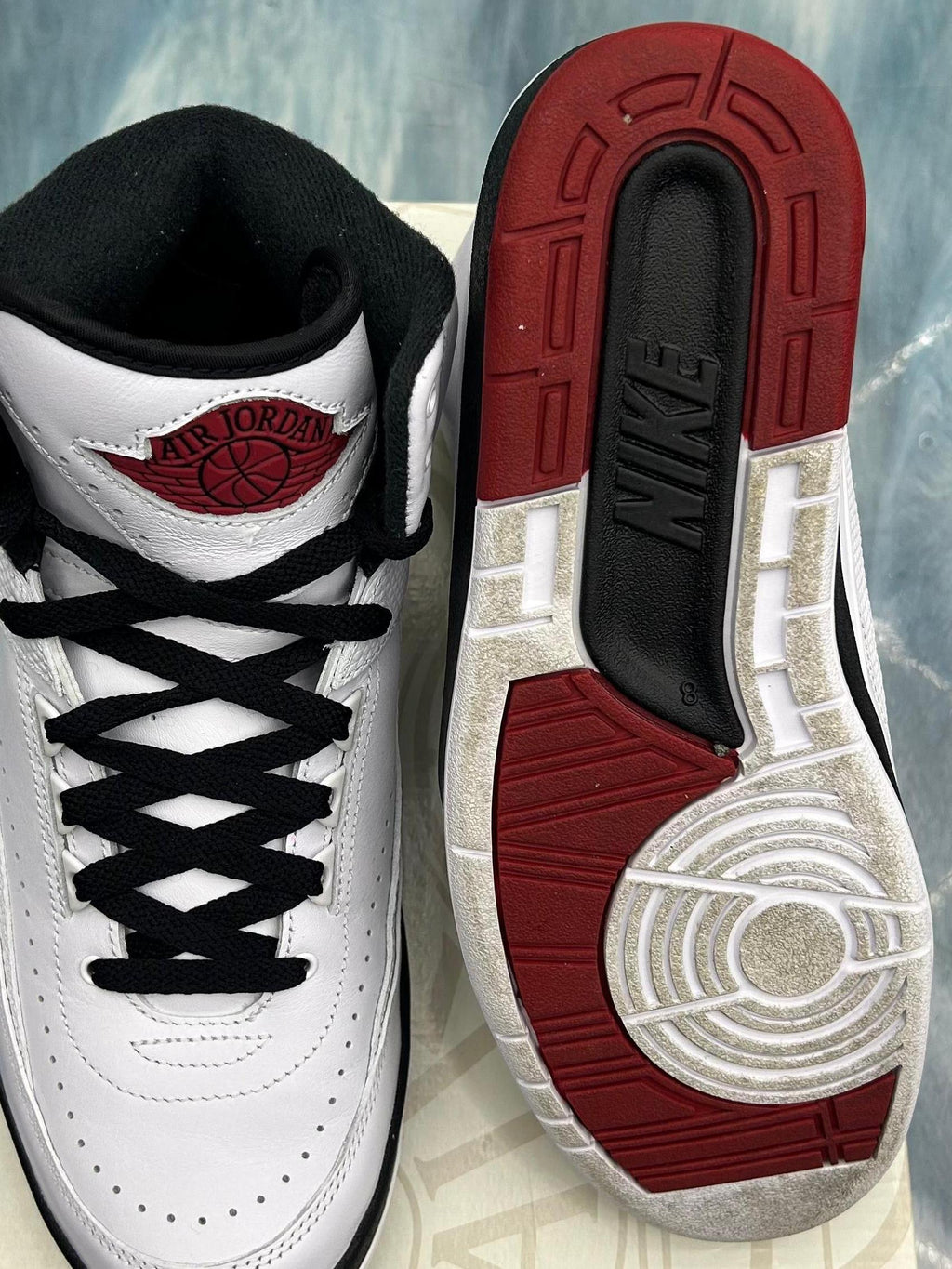Pre-owned Jordan 2 Retro Chicago sneakers, size 8. White leather upper, black laces, red Air Jordan logo, and red/black outsole.