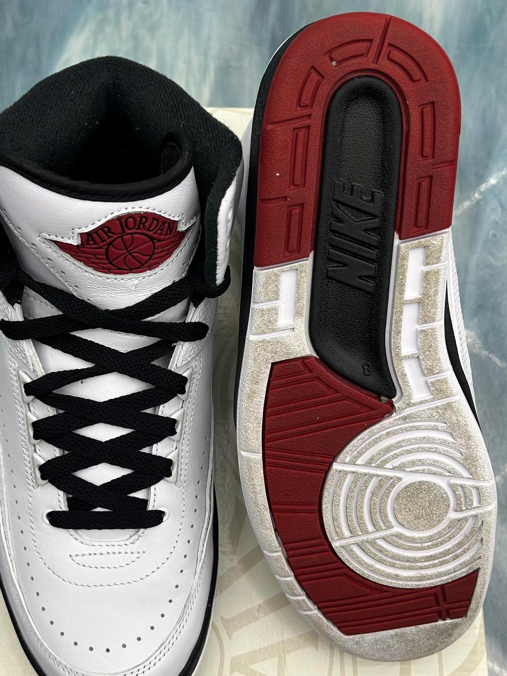 Pre-owned Jordan 2 Retro Chicago sneakers, size 8. White leather upper, black laces, red Air Jordan logo, and red/black outsole.