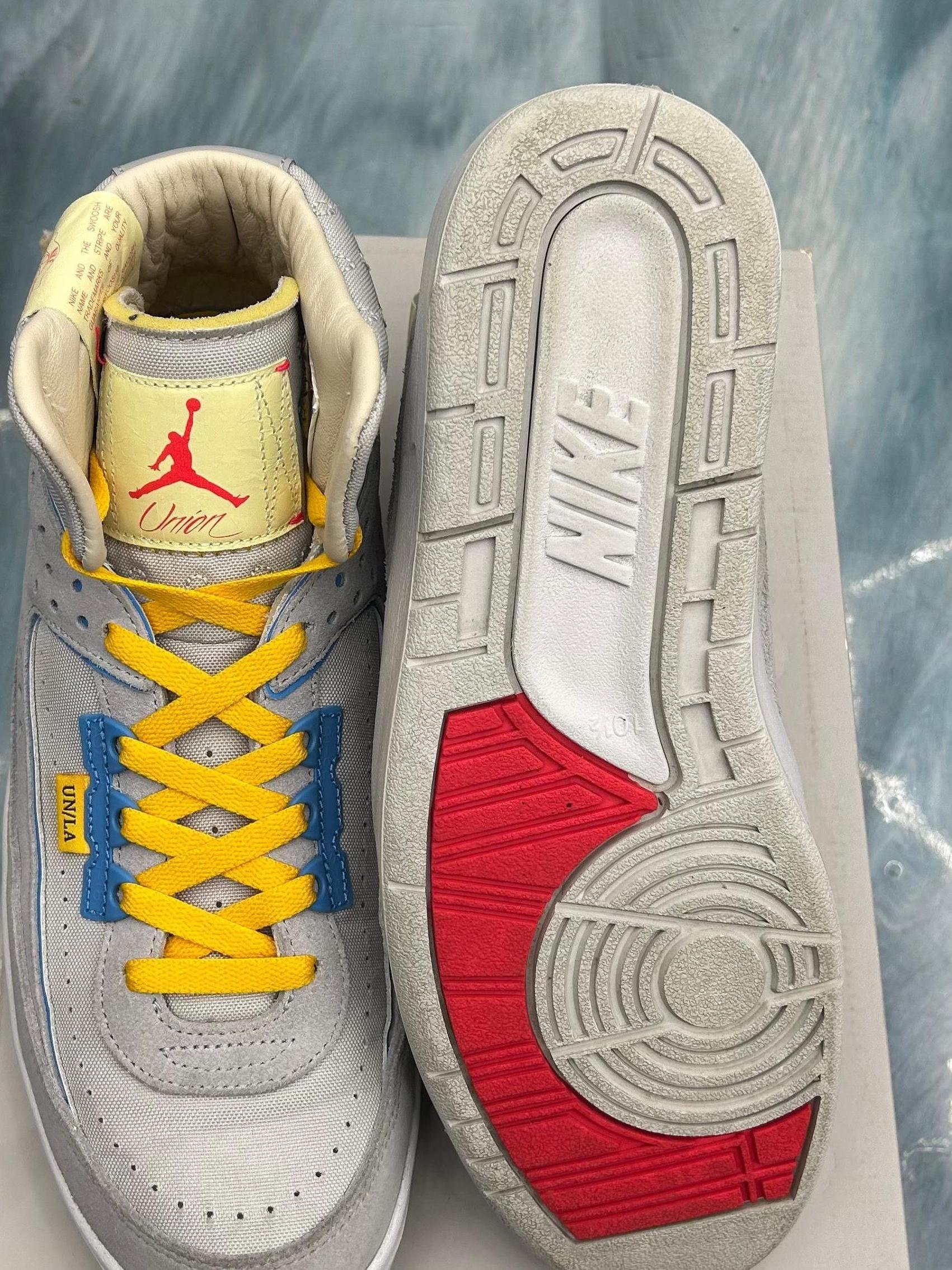JORDAN 2 RETRO SP UNION GREY FOG PRE OWNED SIZE 10.5, light grey with yellow laces, red Jumpman logo, and red outsole.