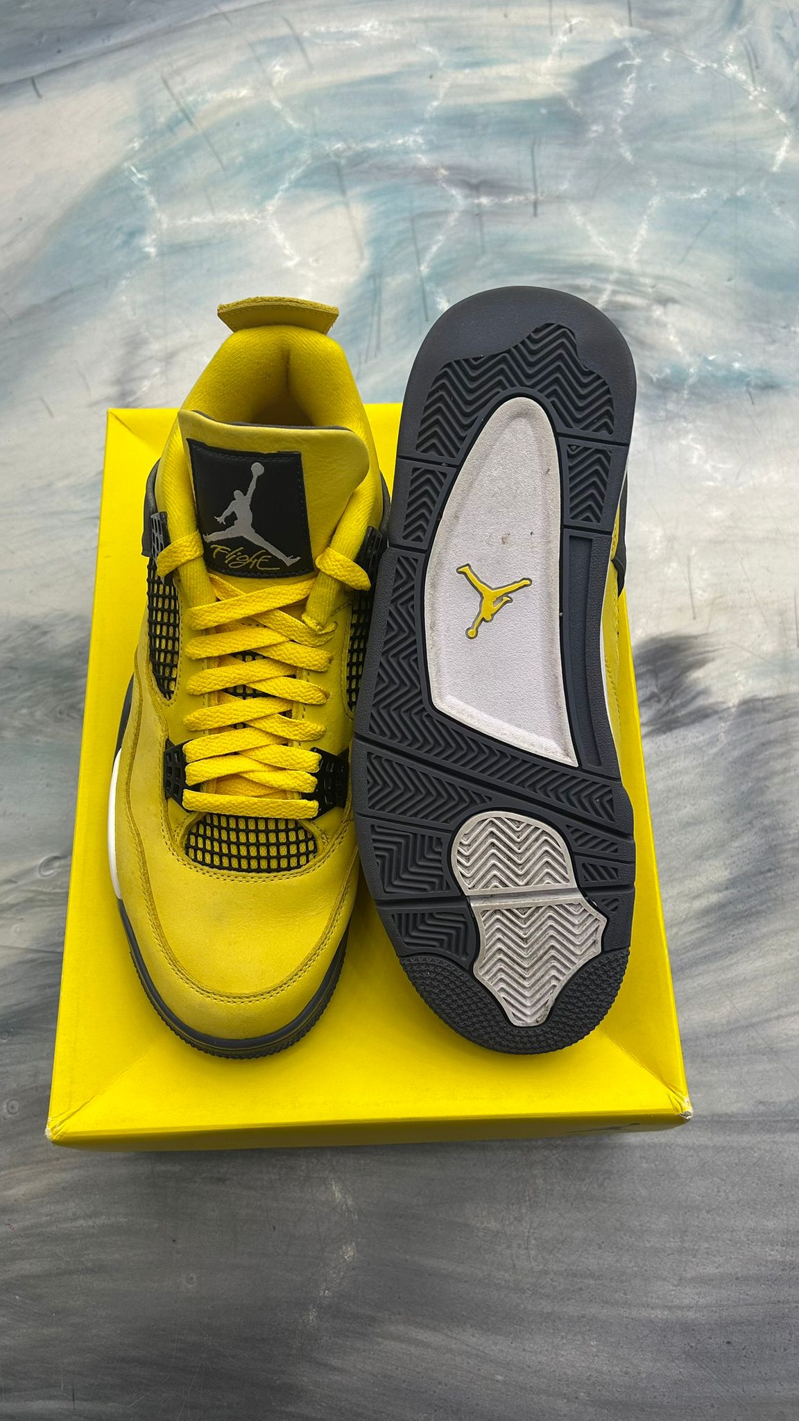Pre-owned Jordan 4 Retro Lightning sneakers, size 10, vibrant yellow leather with black accents and Jumpman logos.