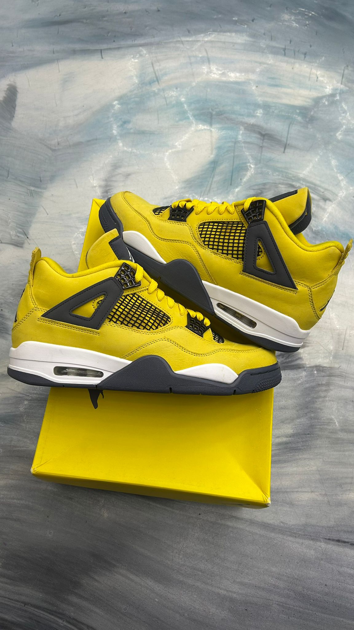 Pre-owned Jordan 4 Retro Lightning sneakers, size 10, vibrant yellow nubuck with dark grey accents and white soles.