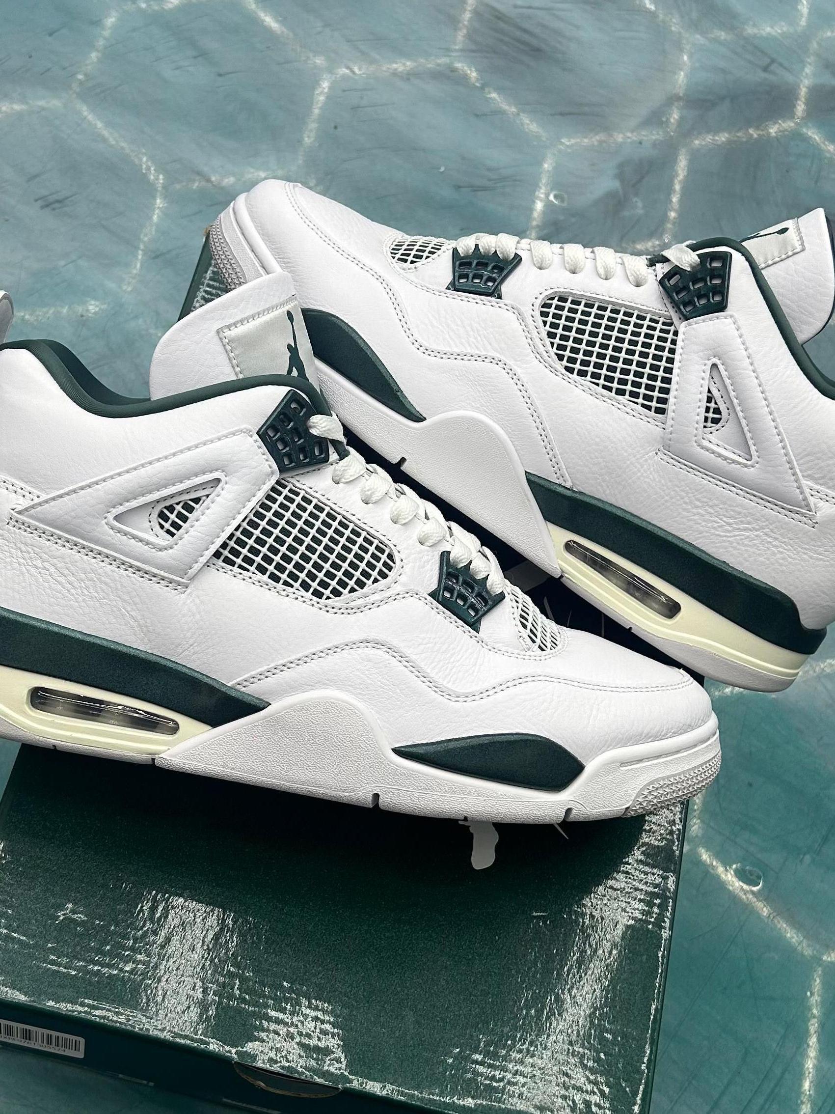 Pre-owned Jordan 4 Retro Oxidized Green sneakers, white leather with dark green accents and visible air unit.