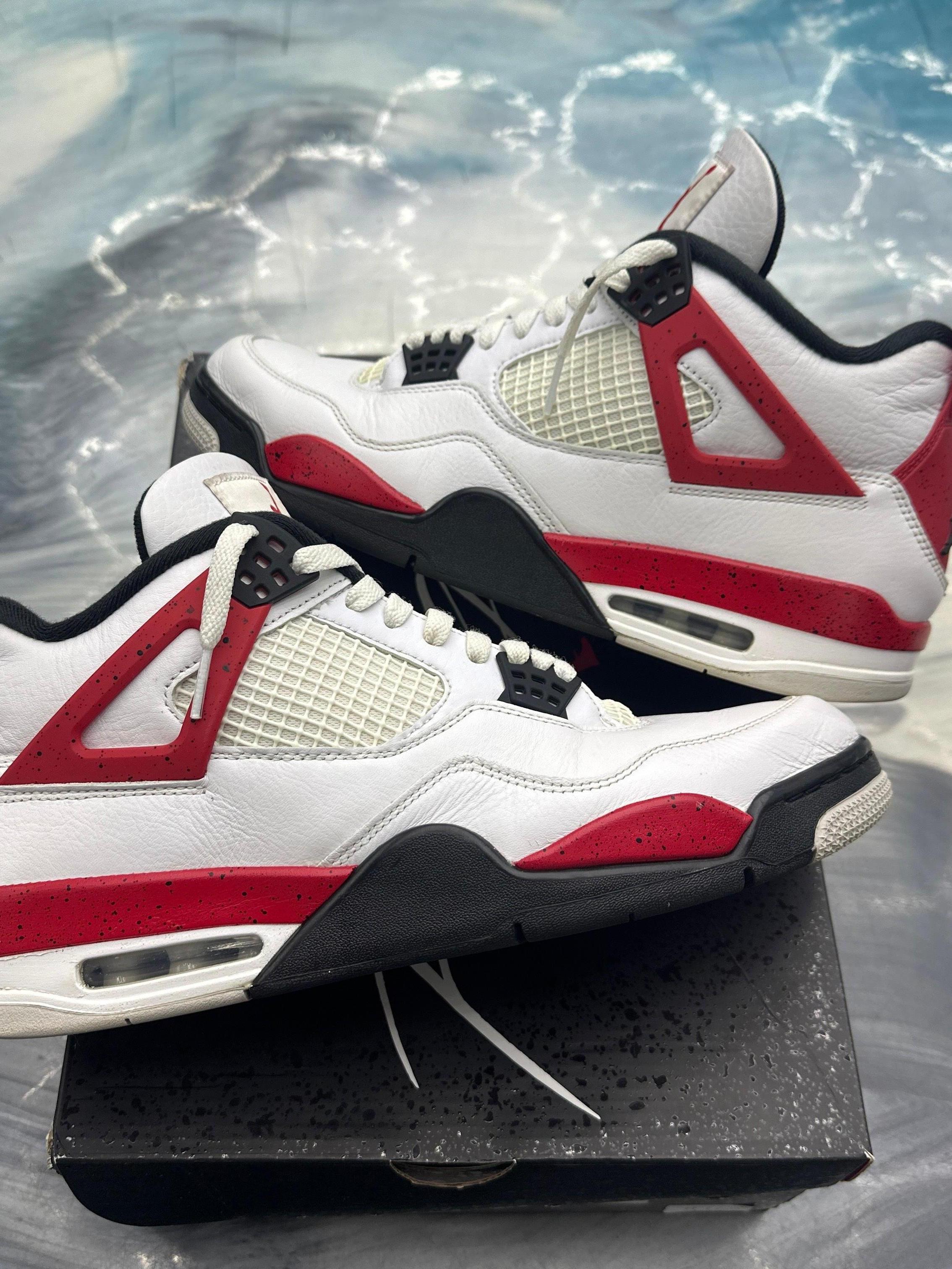 JORDAN 4 RETRO RED CEMENT pre-owned size 12 sneakers, white leather with red and black accents.