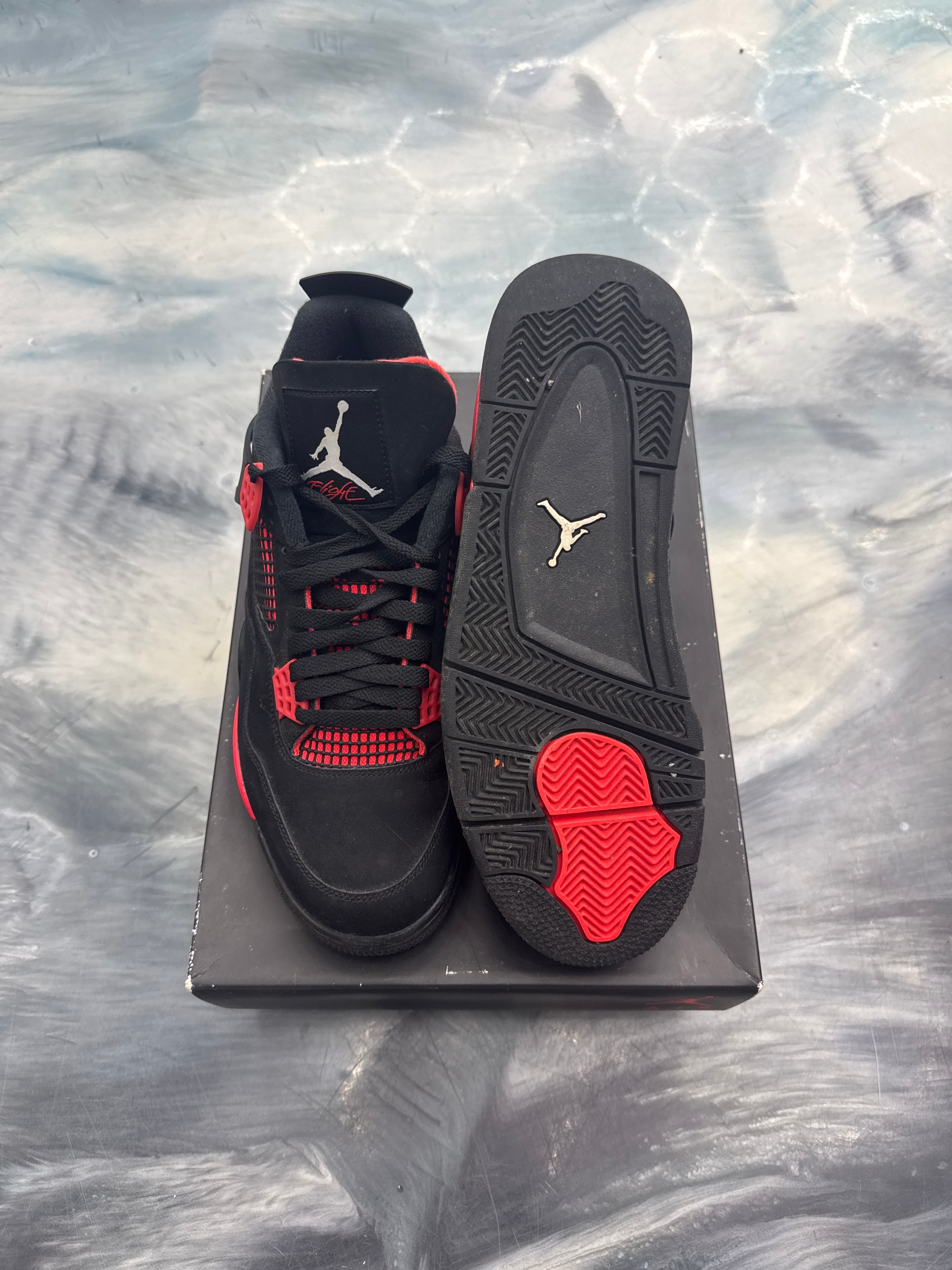 Pre-owned Jordan 4 Retro Red Thunder, black nubuck with red accents, size 11, top and sole view.