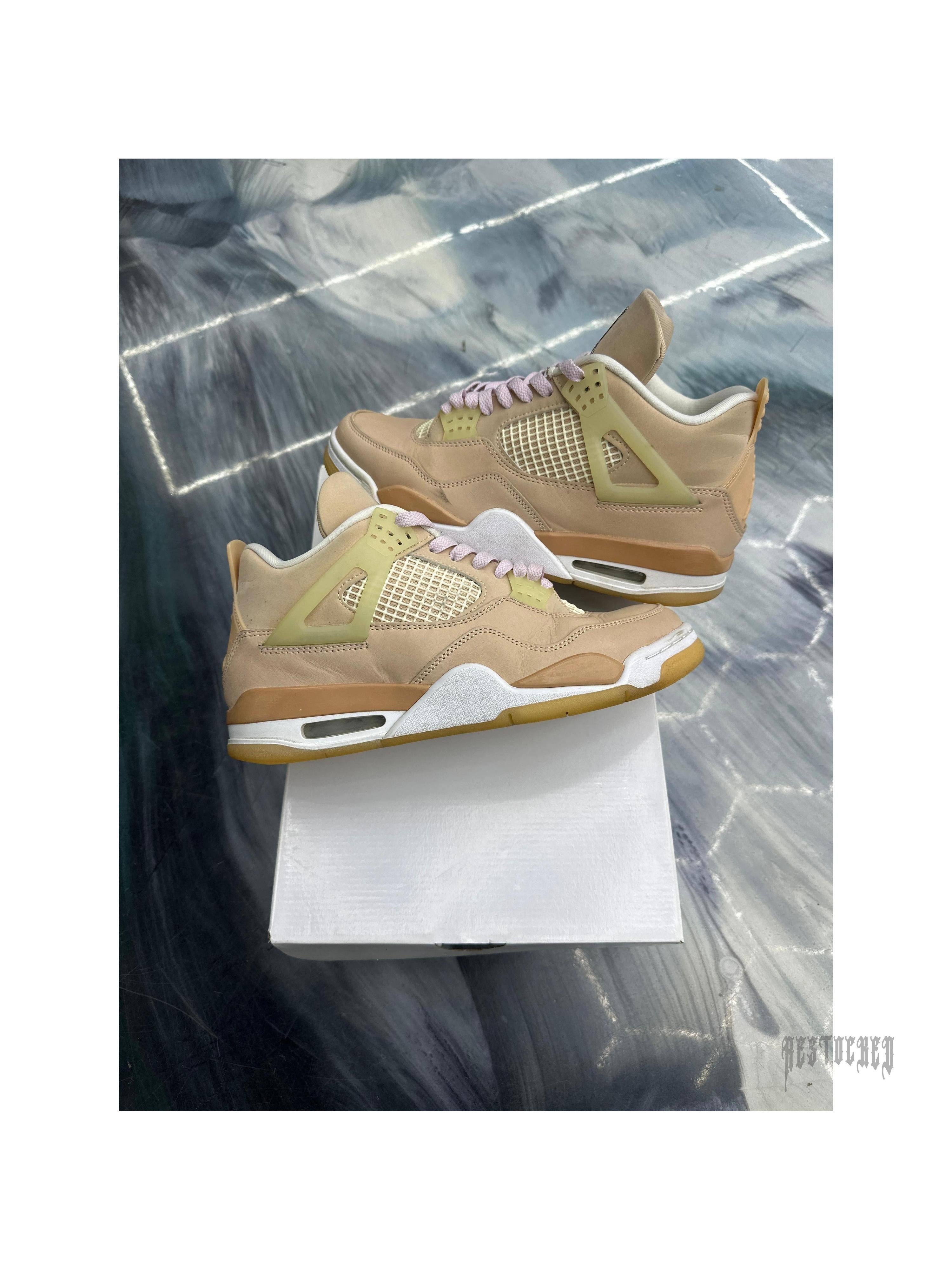 JORDAN 4 Retro Shimmer pre-owned sneakers in tan leather with mesh, pink laces, and white soles.