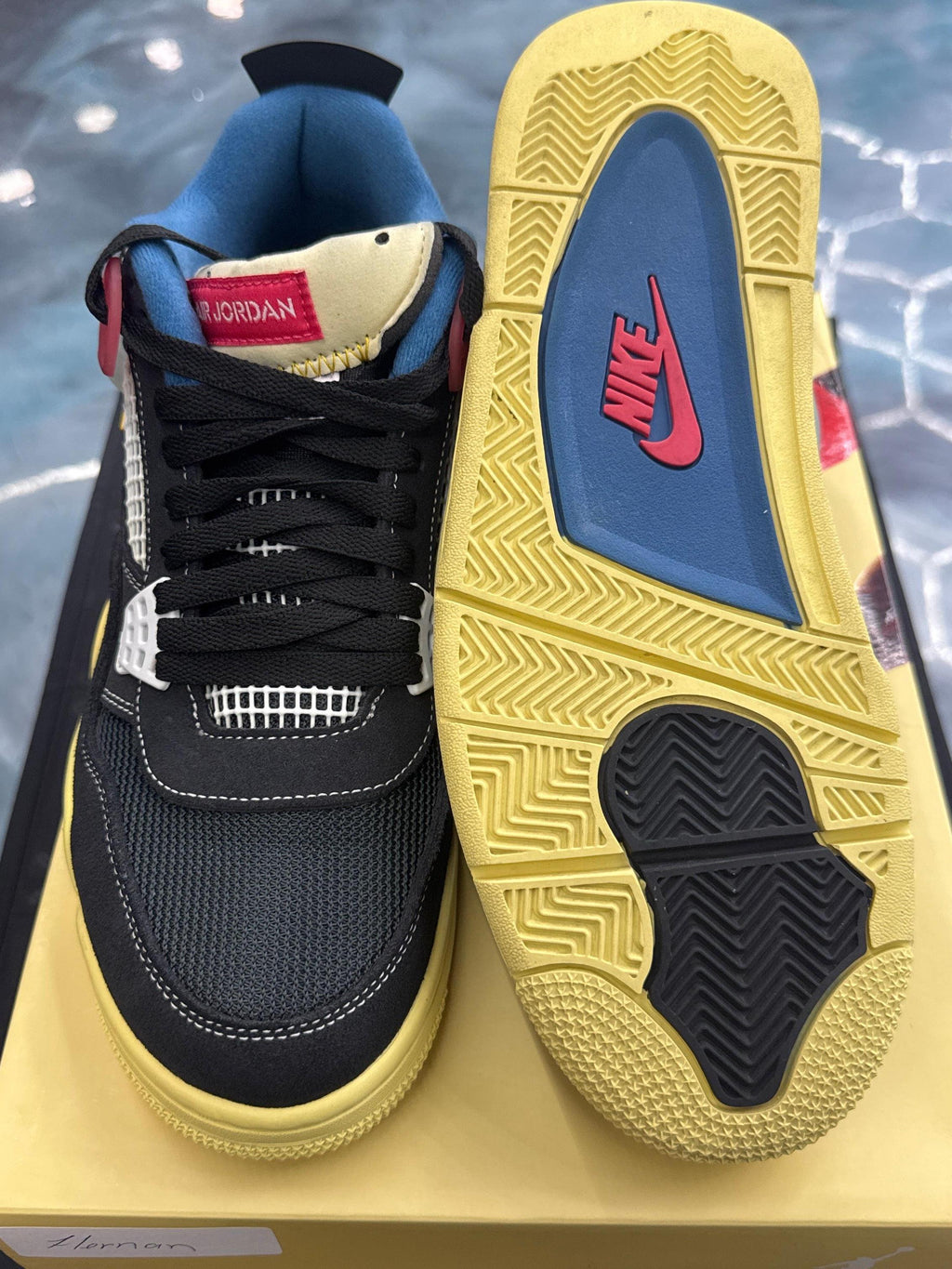 JORDAN 4 Retro Union Off Noir pre-owned size 10.5, black mesh and suede, yellow sole with blue and red Nike logo.