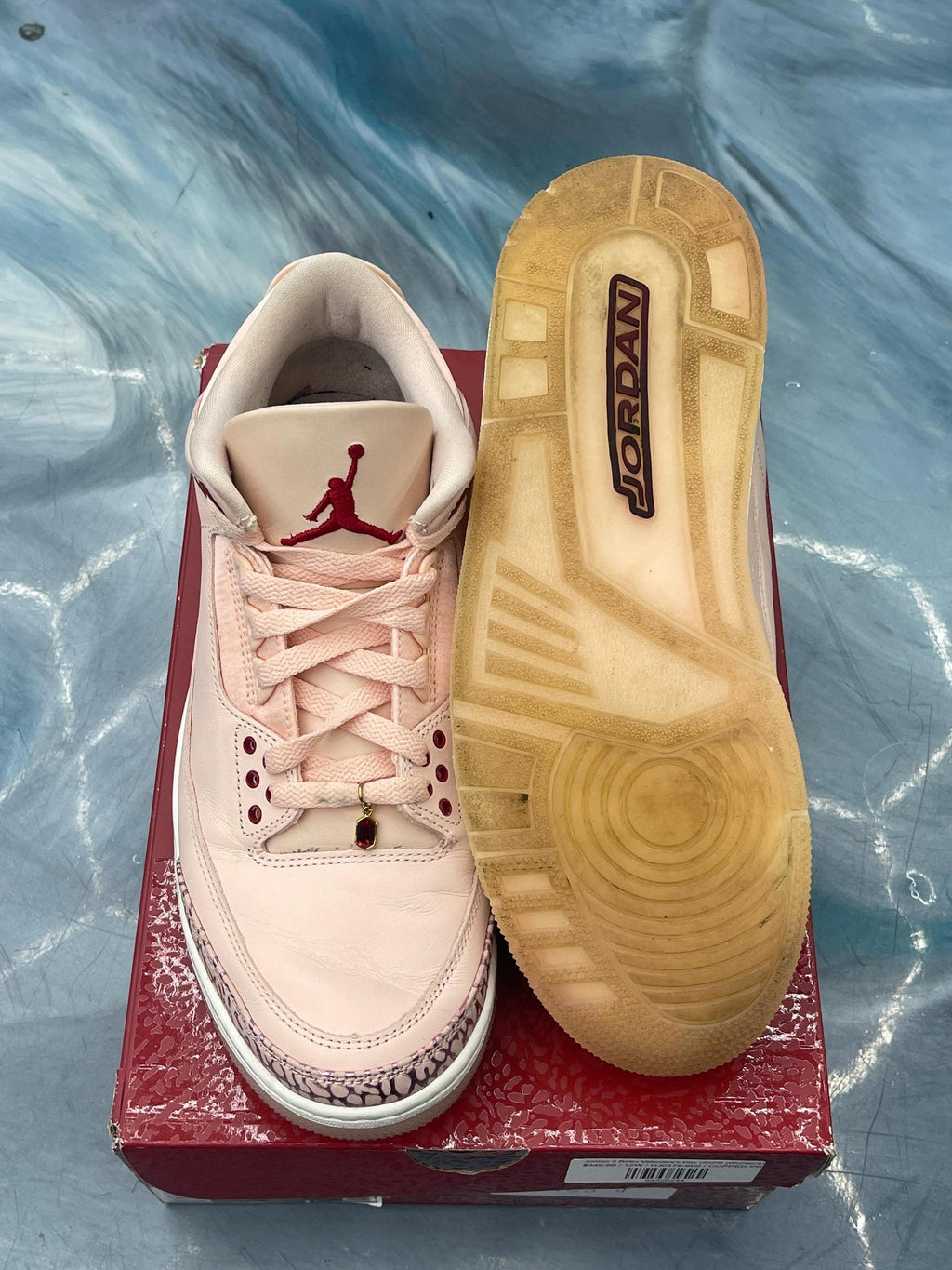Pre-owned Jordan 4 Retro Valentines Day light pink sneaker, size 12W/10.5, with red accents and worn sole.