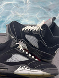 Pre-owned Jordan 5 Retro Black Metallic Reimagined size 9.5 sneakers with white laces, black suede, and speckled soles.