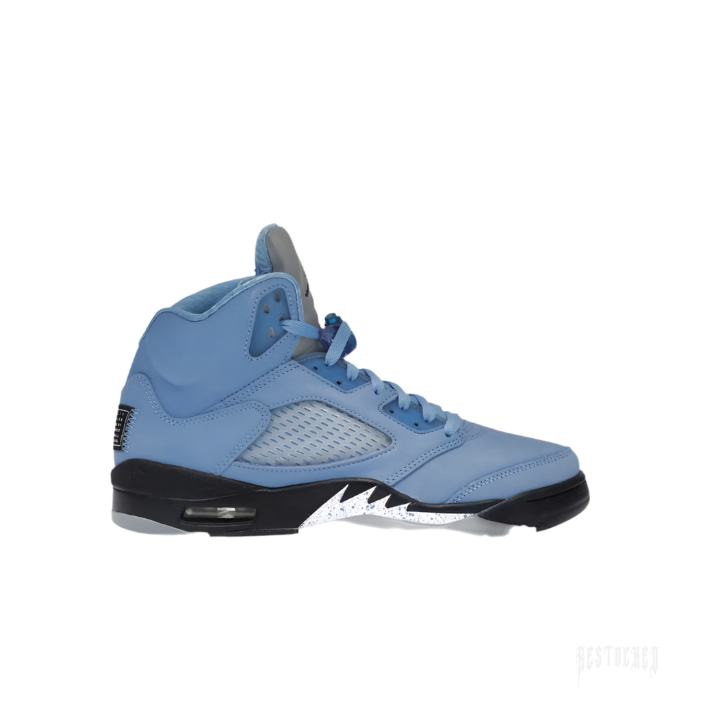 JORDAN 5 RETRO UNC UNIVERSITY BLUE sneaker, light blue leather upper, black midsole with white speckled shark teeth.