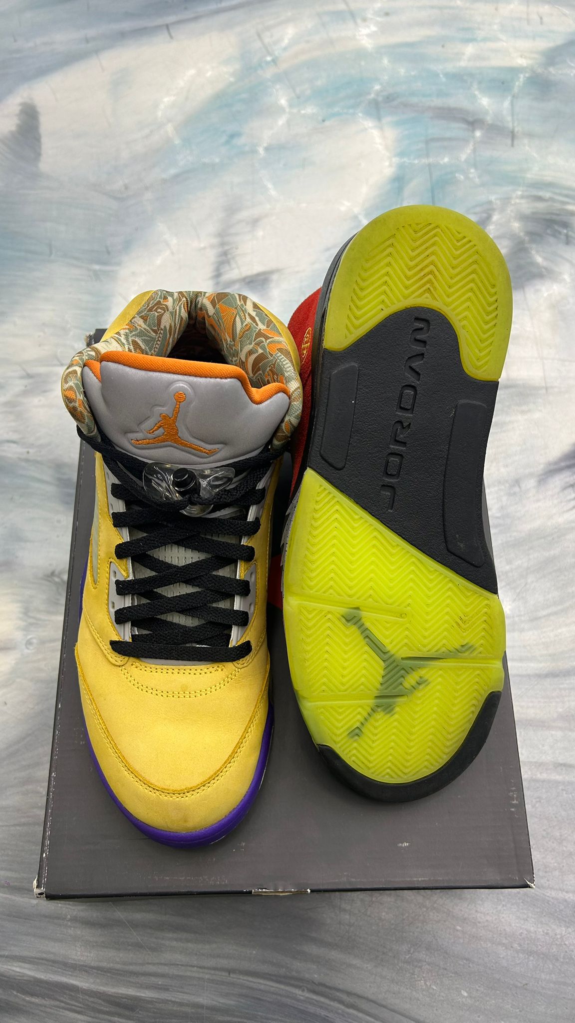 Pre-owned Jordan 5 Retro "What The" size 11, yellow suede upper, black laces, gray tongue with orange Jumpman, and vibrant yellow sole.