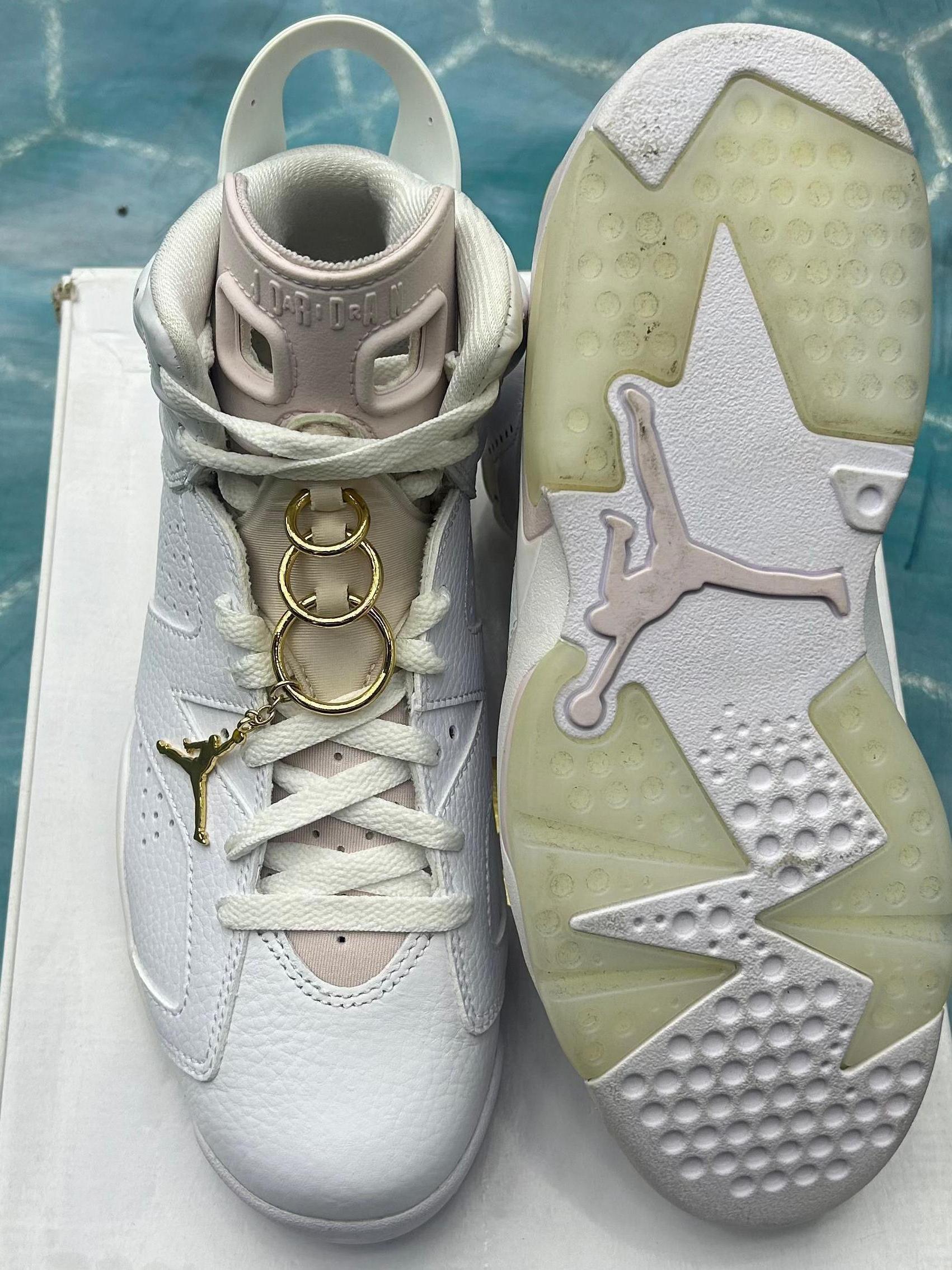 JORDAN 6 RETRO GOLD HOOPS (WOMENS) PRE OWNED SIZE 9.5W/8M, white leather, pink tongue, gold lace rings and Jumpman charm.